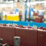 Golf cart batteries on an assembly line