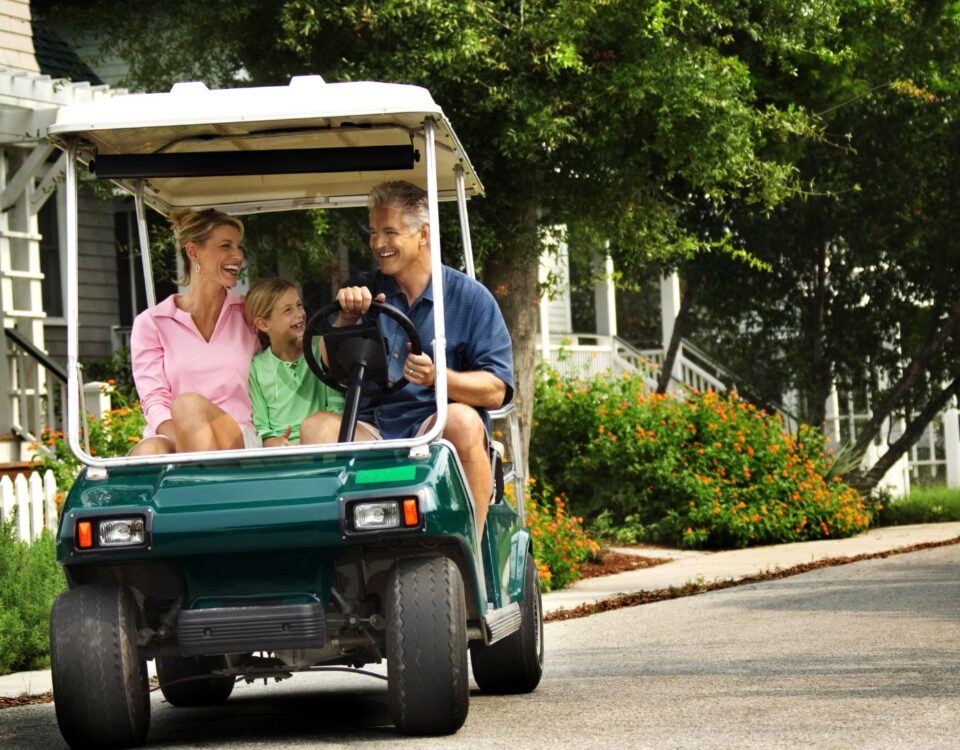 A family driving a street legal golf cart