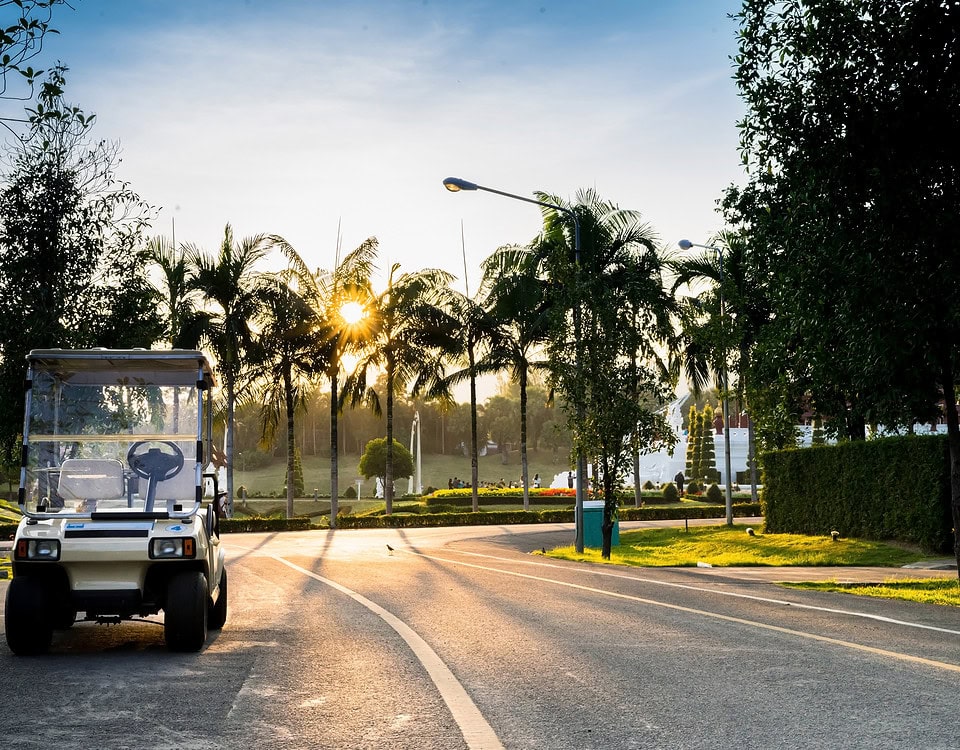 Golf carts in the garden a beautiful on sunset